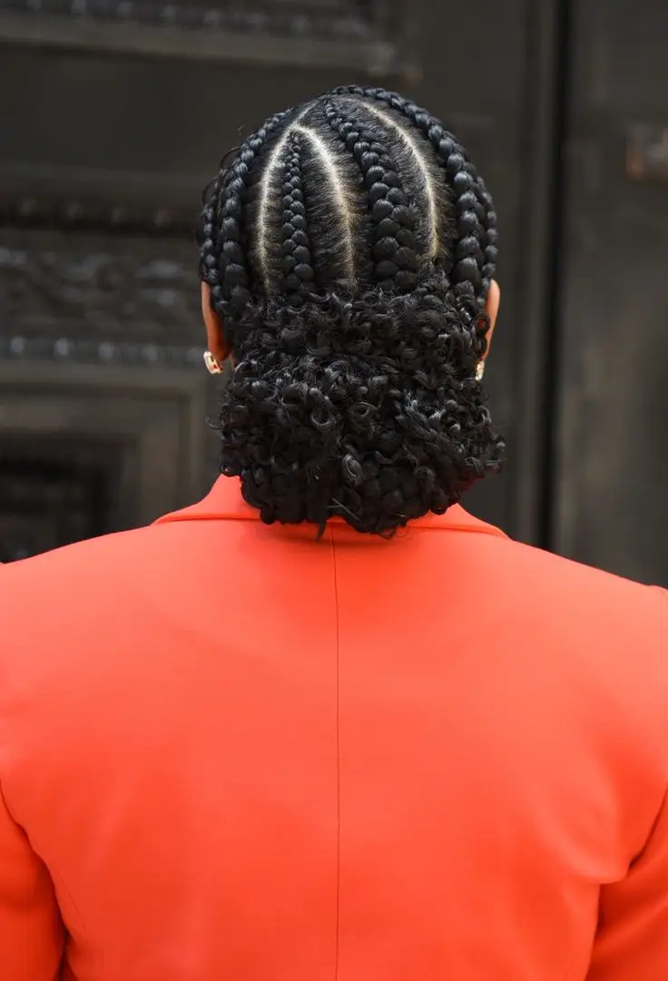 Rear view of cornrows gathered into a textured curly low bun