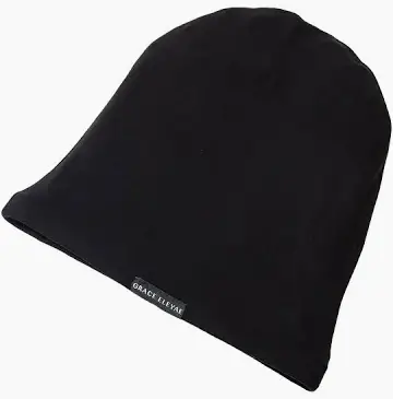 Woman putting on a black Grace Eleyae satin-lined cap