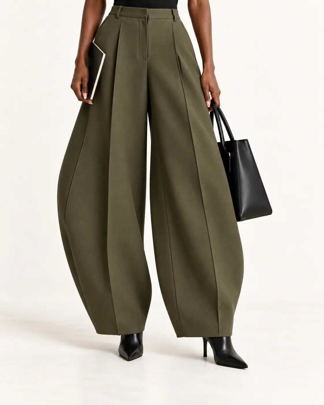 Olive barrel-leg dress pants worn with slim pointed black ankle boots