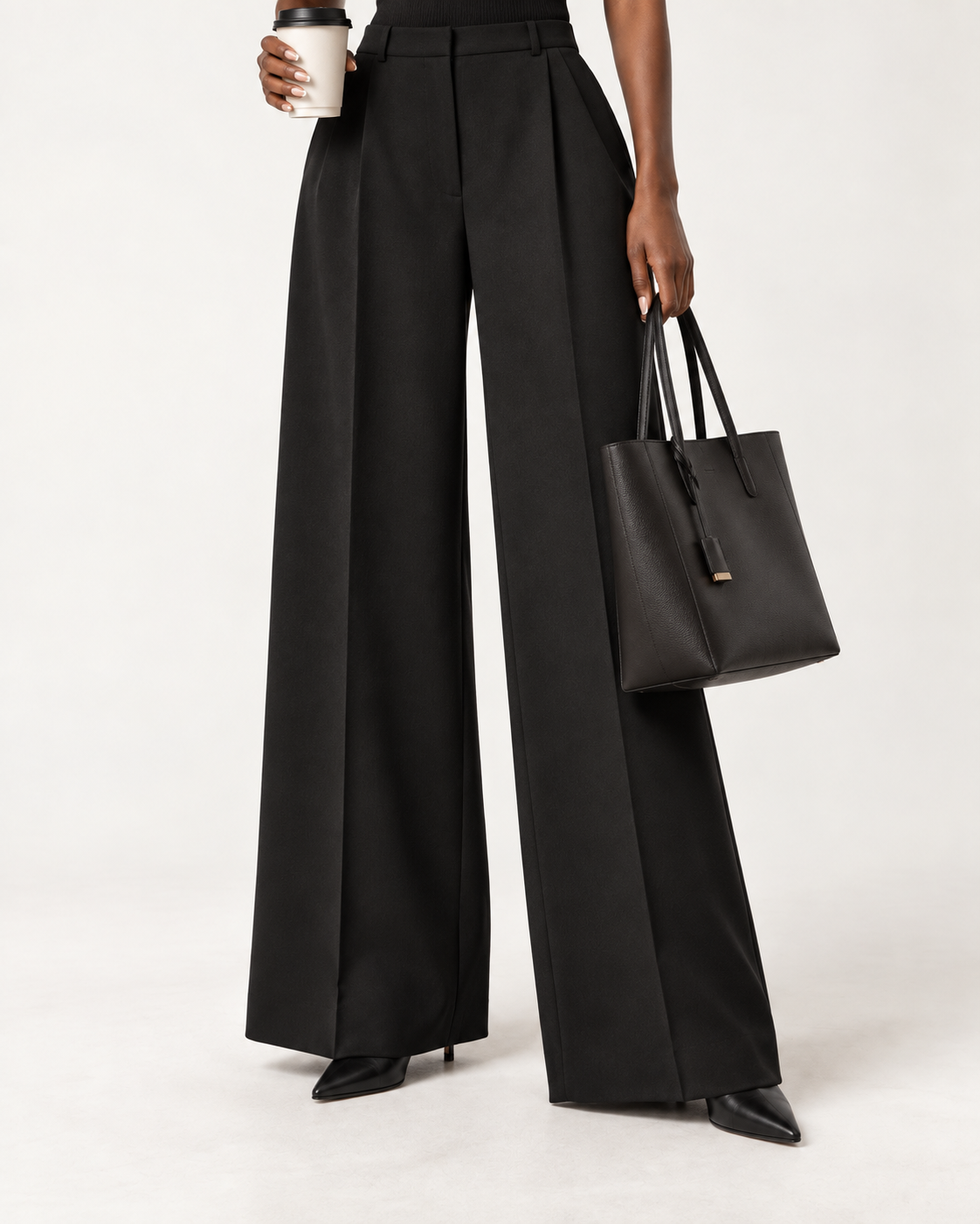 Black full-length wide-leg dress pants worn over pointed black ankle boots