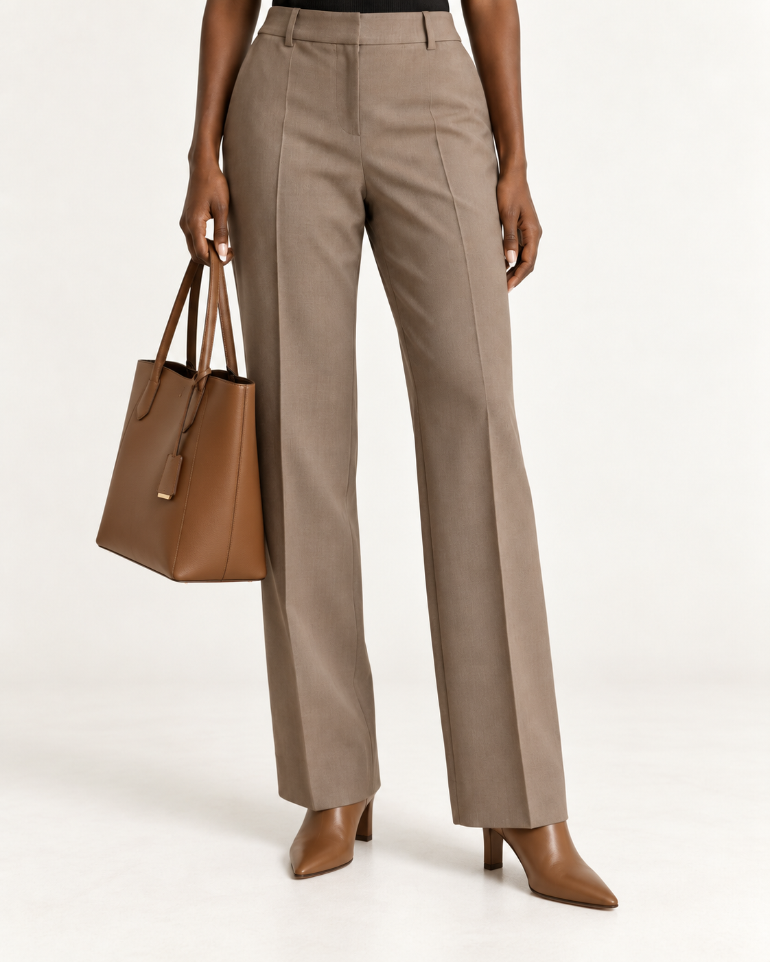Taupe straight-leg dress pants worn with brown almond-toe ankle boots