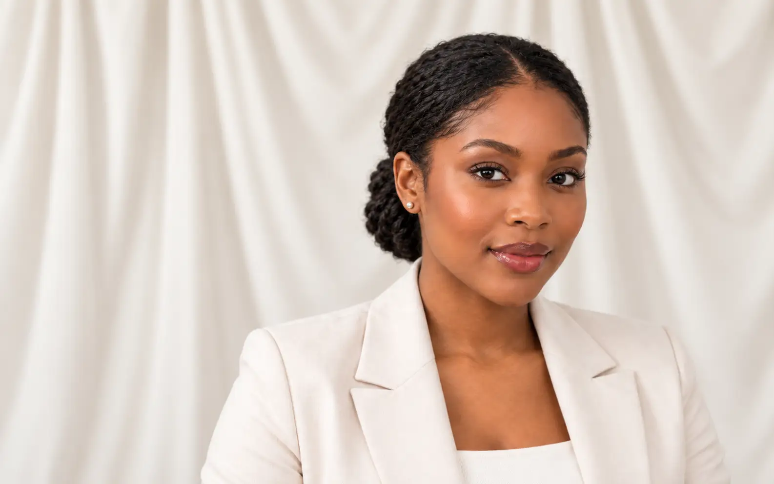 Black woman wearing a polished natural hairstyle during a virtual job interview